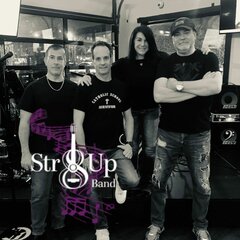 Str8up Band. 4 members standing in front of stage.