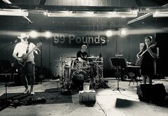 99 Pounds band - with musicians playing guitars and drums